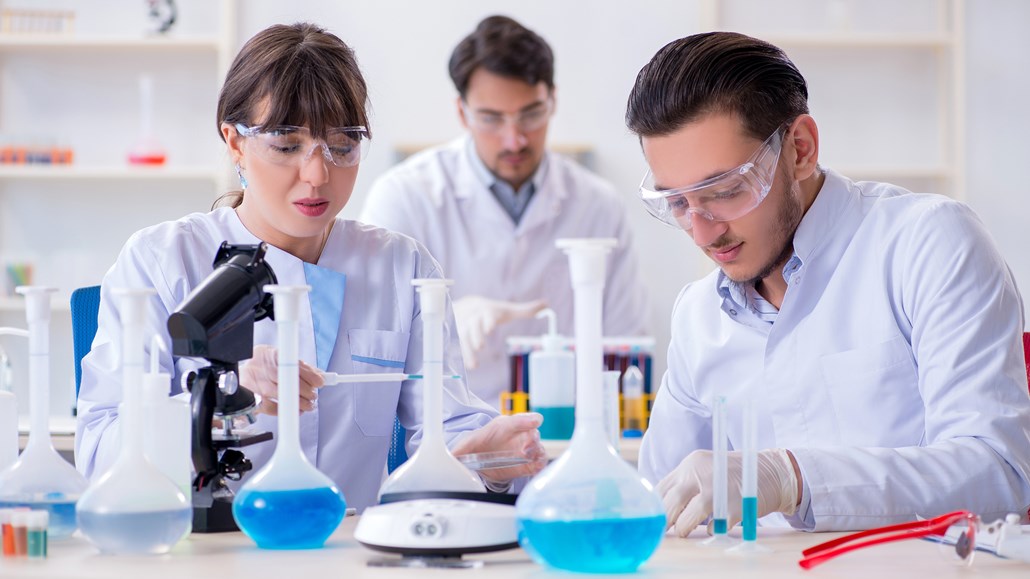 team of chemists working in laboratory